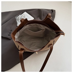 Detailed interior of the woven tote bag showing the spacious lining and zipper pocket