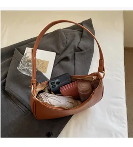Detailed interior of a brown crescent shoulder bag showing large storage capacity