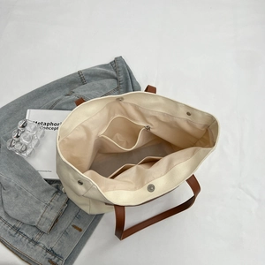 Interior layout of canvas tote bag with zipper pocket and magnetic buckle detail