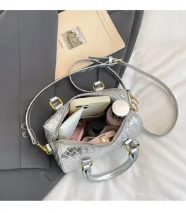 Internal view showing spacious capacity of the silver woven crossbody bag with daily items