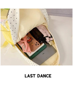 Detailed view of spacious interior storage in yellow polka dot school backpack
