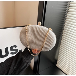 Detail of sequin evening bag with champagne gold pleats and rhinestone metal clasp