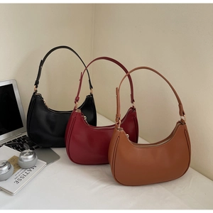 Detailed shot of retro crescent hobo bags in black, burgundy, and caramel brown colors