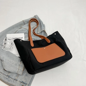 Large black canvas tote bag with brown leather straps and front pocket for women