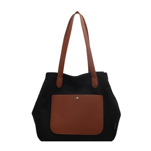 Minimalist black canvas tote bag with brown leather pockets and high-capacity storage