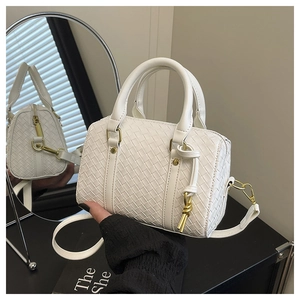 Detail of white woven leather boston bag with gold hardware and dual handles
