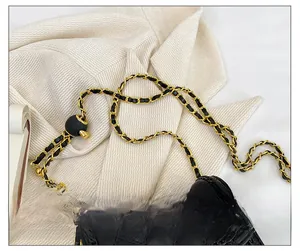 Détail en cuir matelassé noir avec bandoulière chaîne dorée et boule de réglage ronde