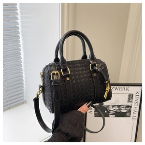 Close-up of black woven leather mini Boston bag with vintage gold hardware details