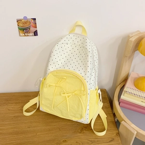 Sweet student backpack with yellow and white polka dot design and cute decorative bows