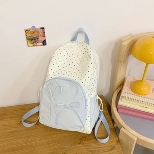 Sweet polka dot backpack with blue bow details and a minimalist school aesthetic