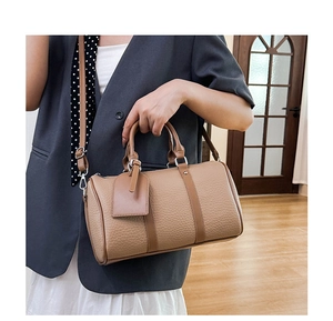 Detailed view of the khaki pebbled leather Boston bag showing textures and silver hardware