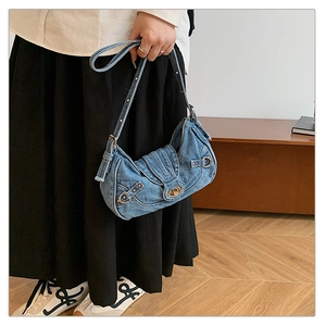 Detail of blue denim hobo bag with silver rotary lock and adjustable shoulder strap