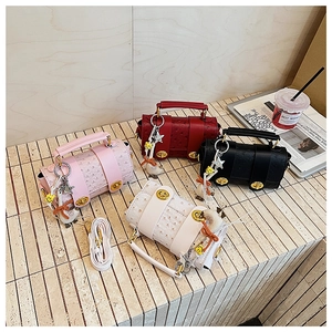 Detailed view of ostrich texture mini bags with gold clasps and decorative charms