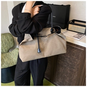 Detail of minimalist tote bag with leather straps on a chair in a trendy studio setting