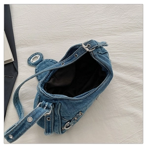 Detailed top view of moon-shaped denim shoulder bag with frayed edges and silver hardware