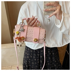 Pink ostrich pattern crossbody bag with gold lock detail and cute duck charm