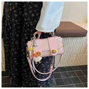 Pink ostrich pattern crossbody bag featuring a cute white duck charm and gold twist lock