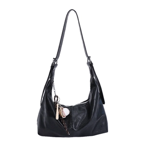 Minimalist black hobo shoulder bag in synthetic leather with baseball charm on white background