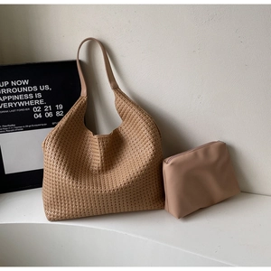 Top-down view of woven khaki tote bag and matching zipper pouch on white stairs
