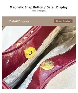 Macro shot of magnetic clasp on burgundy leather shoulder bag with chevron lining