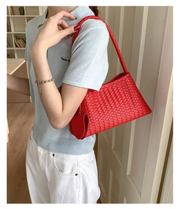 Detail of red woven leather shoulder bag with matching mini round coin purse charm