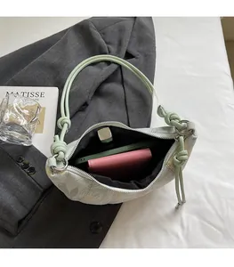 Detail of floral dumpling bag interior showing space for phone, wallet and lipstick