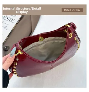 Inside view of wine red patent leather handbag showing zipper pocket and magnetic closure