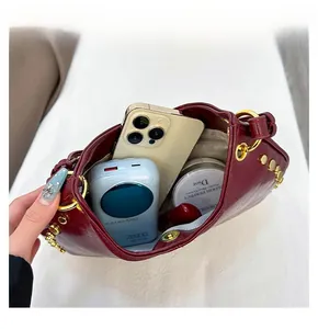 Detailed internal view showing large storage space for phone and makeup in red handbag