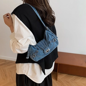 Retro blue denim underarm bag with Y2K metal buckle and rivets worn by model