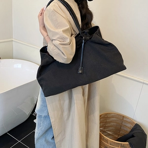 Large black textured canvas tote bag for women with a long shoulder strap for daily use