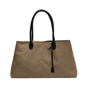 Minimalist brown matte canvas tote bag with black leather handles and vintage styling