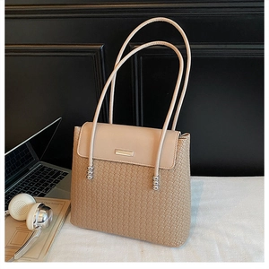 Detailed view of beige crossbody bag with leather weaving texture and silver bead accents