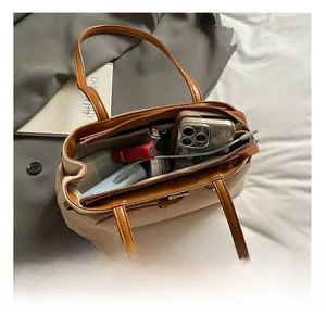 Detail view of canvas bag interior showing large capacity for phone and cosmetics