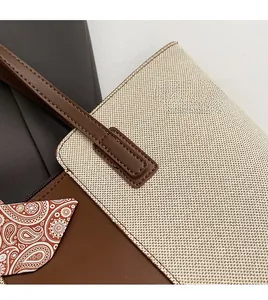 Close-up of canvas tote bag showing handmade stitching and paisley leather details
