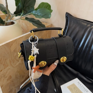 Black ostrich-pattern mini pillow bag with gold ring buckle and cute charms accessories