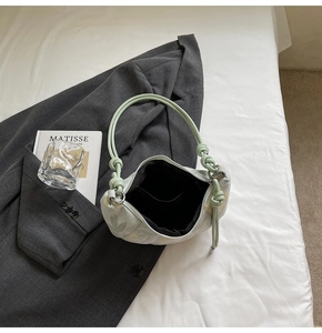 Top view of light green dumpling bag with knot handle and black interior pocket