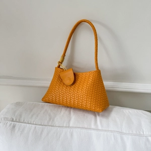 Minimalist woven orange underarm bag with top handle for summer 2025 trendy style
