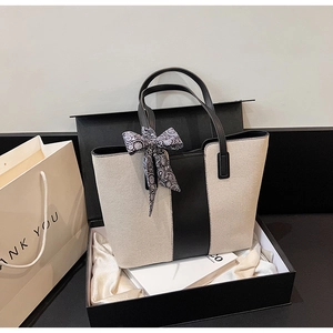 Canvas tote bag with black leather trim and silk scarf detail in elegant gift box