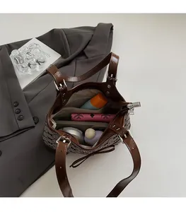 Detailed view of tote bag interior with multiple compartments and a small pink wallet