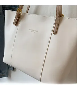 Detail of high-quality PU leather tote bag showing fine stitching and metal buckles
