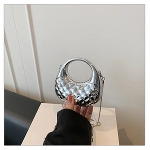Detail of silver mirror acrylic bag with round handle and diamond quilted texture