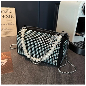 Close-up of luxury black Boston bag with sparkling rhinestones and elegant pearl chain