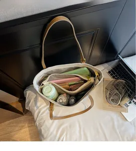Detail view showing spacious interior with multi-compartment storage of minimalist tote bag