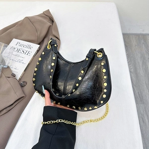 Retro black cracked leather hobo bag with gold studs and a metallic chain strap