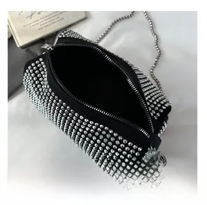 Top view detail showing the single compartment interior and zipper of the rhinestone bag