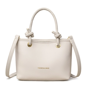 Chic cream-colored lychee leather crossbody square bag with knotted handles and gold hardware