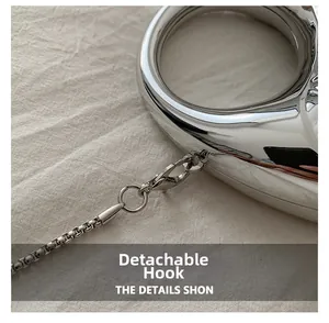 Detail view of the detachable silver lobster clasp and sleek metal chain on acrylic bag