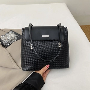 Fashionable black leather and mesh shoulder bag with metallic details for casual commuting