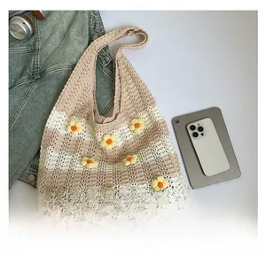 Close-up of hand-crocheted beige tote bag with yellow 3D floral accents and texture