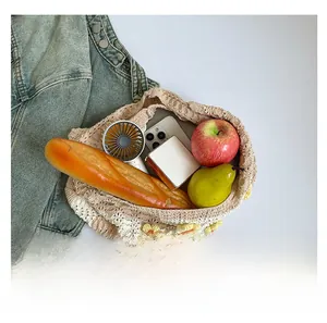 Flat lay of woven tote bag interior showing large capacity for phone and accessories